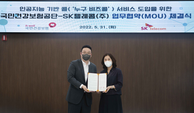 왼쪽부터 SKT 윤현상 에이닷 상품 담당과 국민건강보험공단 이은영 만성질환관리실장이 체결식에서 기념 촬영을 하고 있다.