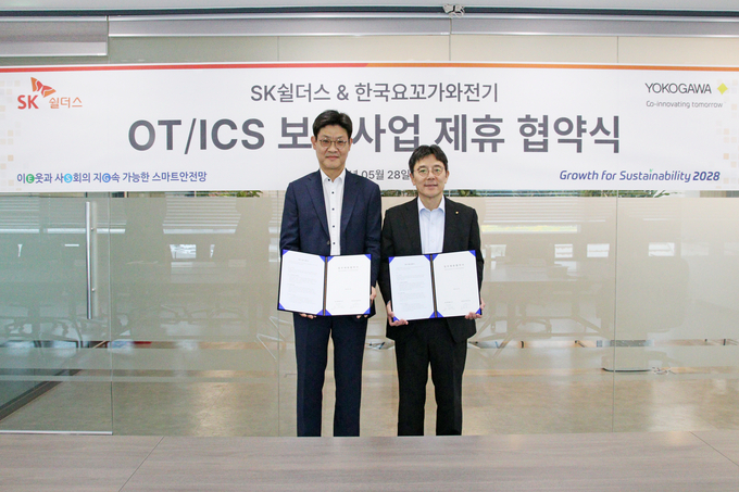 한국요꼬가와전기 코이치 나카지마 대표이사(오른쪽)와 SK쉴더스 김창연 SI/FM사업부장(전무)이 28일 OT/ICS 보안 사업 협력을 위한<br>
업무협약 체결 후 기념촬영을 하고 있다