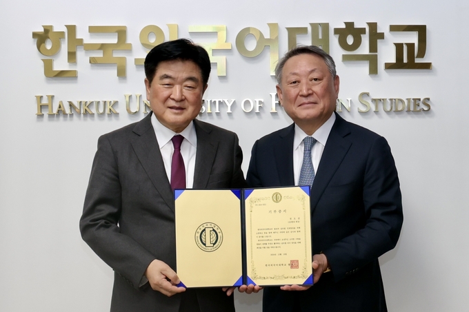 HD현대 권오갑 회장(좌)과 한국외대 박정운 총장(우)이 기부 서명식 후 기념촬영을 하는 모습.