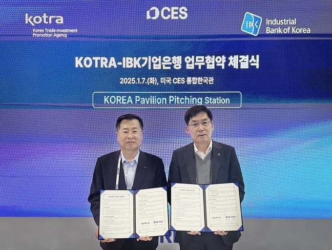 지난 7일(현지시간) 미국 라스베이거스 CES 통합한국관에서 열린 업무협약식에서 김형일 IBK기업은행 전무이사(오른쪽)와 강경성 KOTRA 사장(왼쪽)이 기념촬영을 하고 있는 모습.