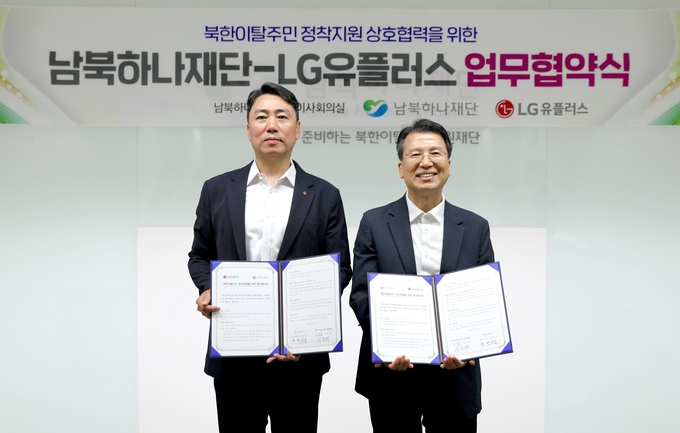 LG유플러스는 통일부 산하 남북하나재단과 북한이탈주민 정착 지원을 위한 업무협약(MOU)을 체결했다. 사진은 서울 마포구 남북하나재단에서 진행된 업무협약식에서 박성순 LG유플러스 기업모바일·전략영업 담당(왼쪽)과 이주태 남북하나재단 이사장 직무대행이 기념촬영을 하고 있는 모습.