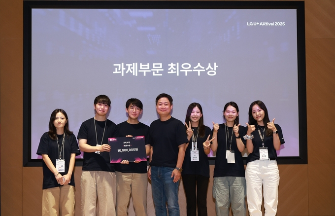 LG유플러스가 사내 AX 문화 확산을 위해 마련한 ‘2025 AXtival’ 행사를 성공적으로 마쳤다. 사진은 최우수상을 수상한 팀과 홍범식 LG유플러스 대표(가운데)가 기념사진을 촬영하는 모습.